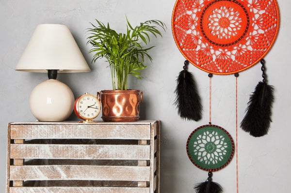An orange dreamcatcher with black and green details