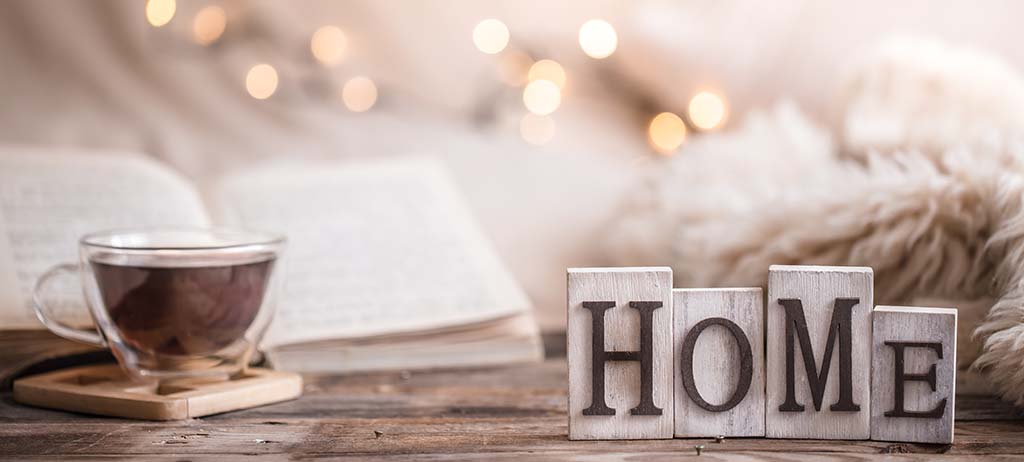 A cup of tea, a book and glowing lights make home - ZenQ Designs