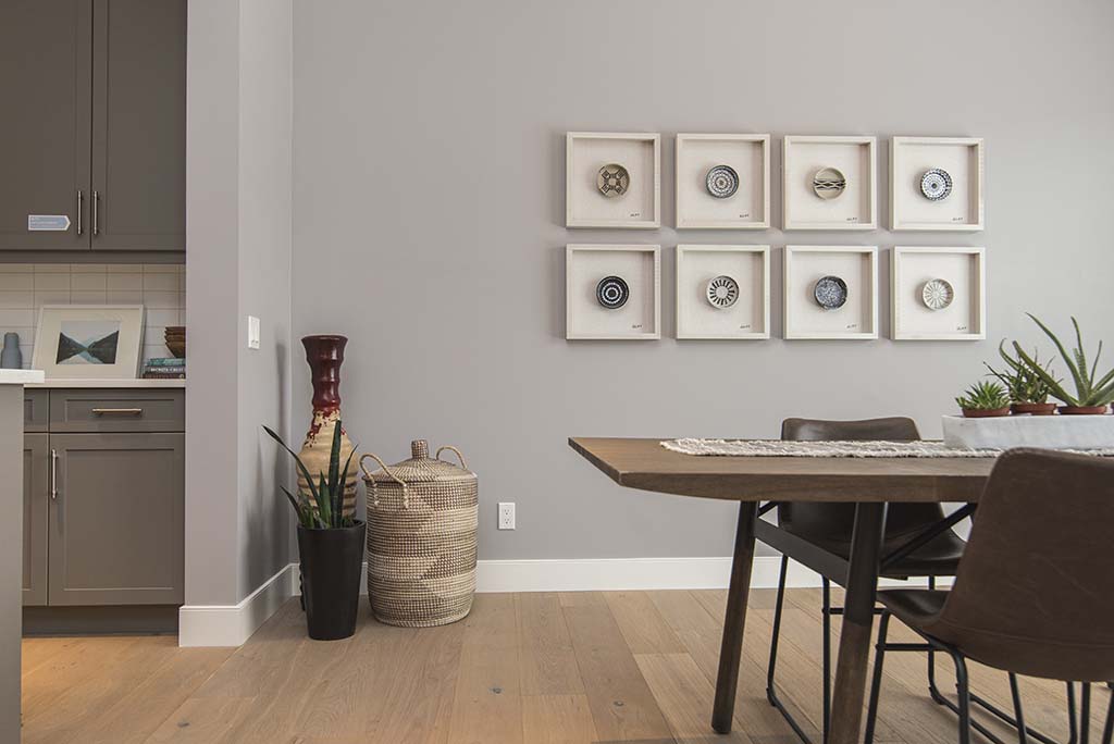 A dining room with white frames and plants - ZenQ Designs