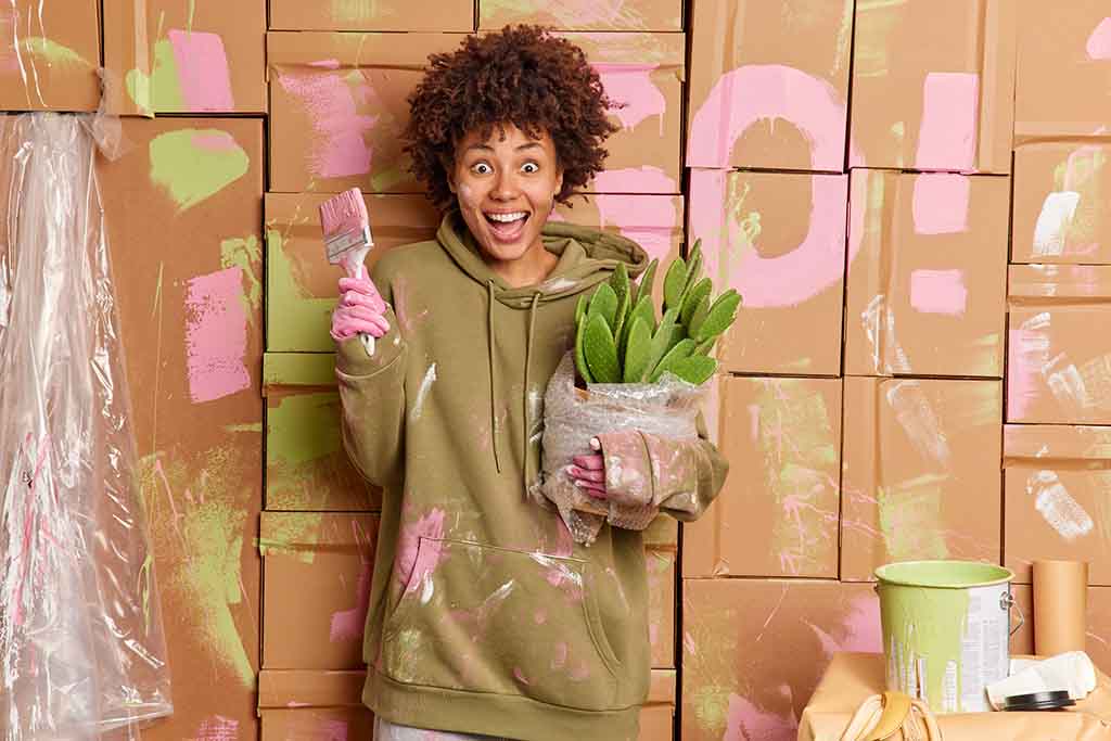 A girl having fun painting the walls - ZenQ Designs