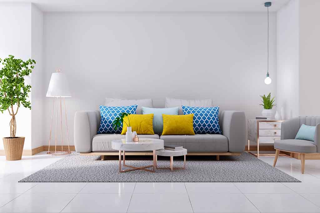 A grey sofa with cushions - ZenQ Designs