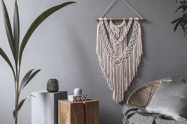 A white macrame on a gray wall